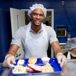 Chris Bosh serves Thanksgiving meals to those in need at the Chapman Partnership organization in Miami, Florida.