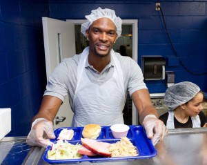 Chris Bosh serves Thanksgiving meals to those in need at the Chapman Partnership organization in Miami, Florida.